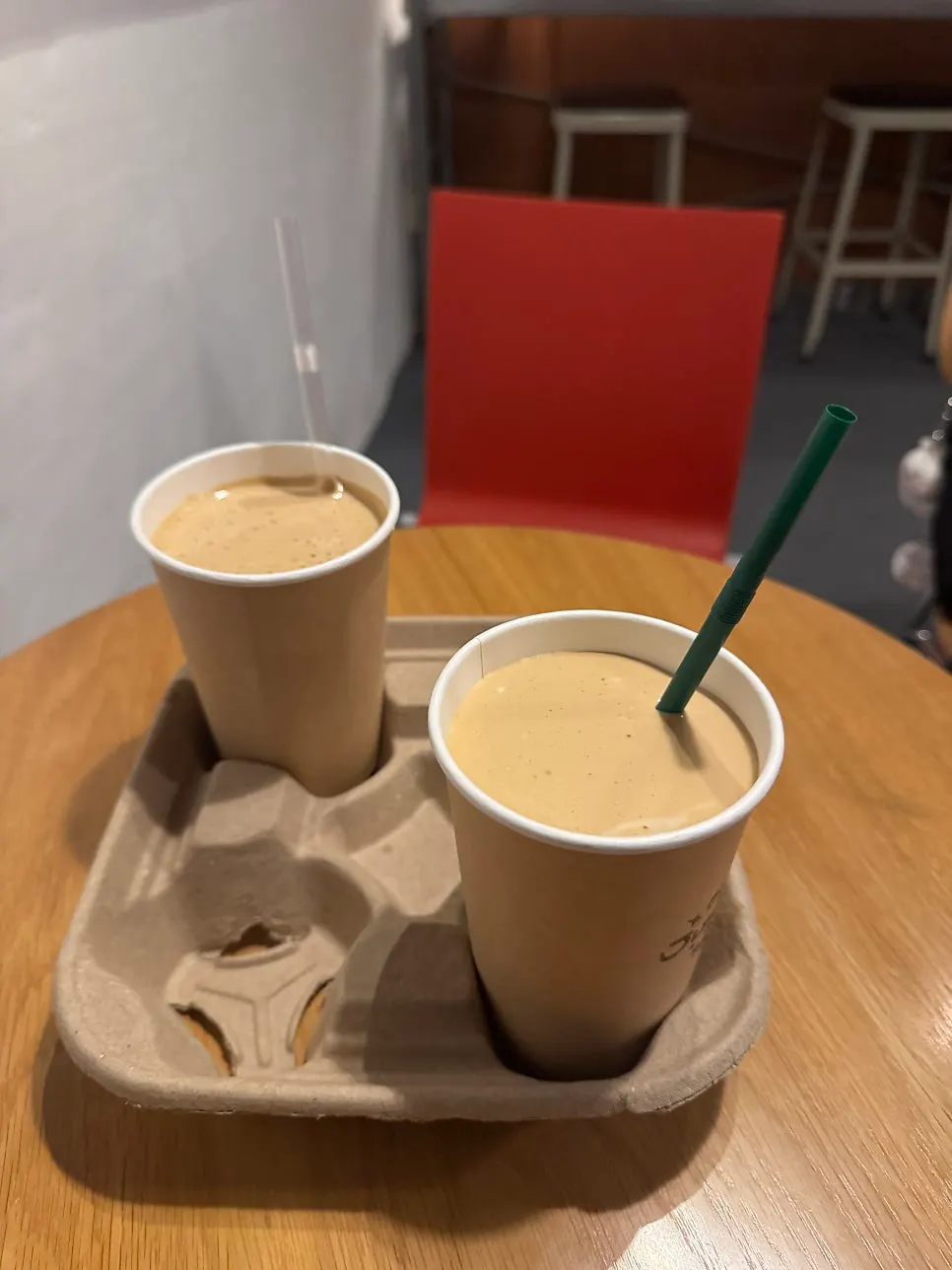 Two coconut lattes set in a cup holder