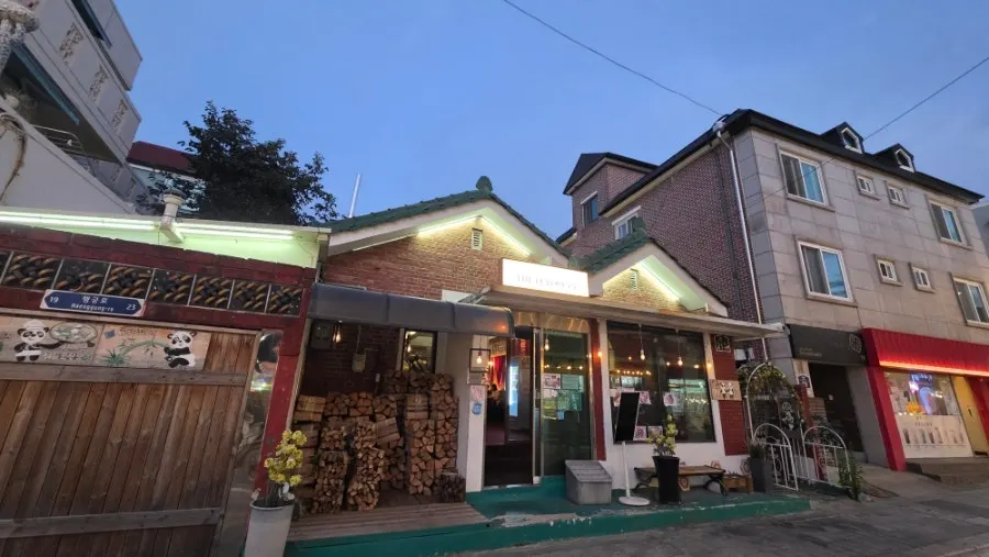 Firewood for the wood-fired oven stacked in front of The European Haenggung Main Branch
