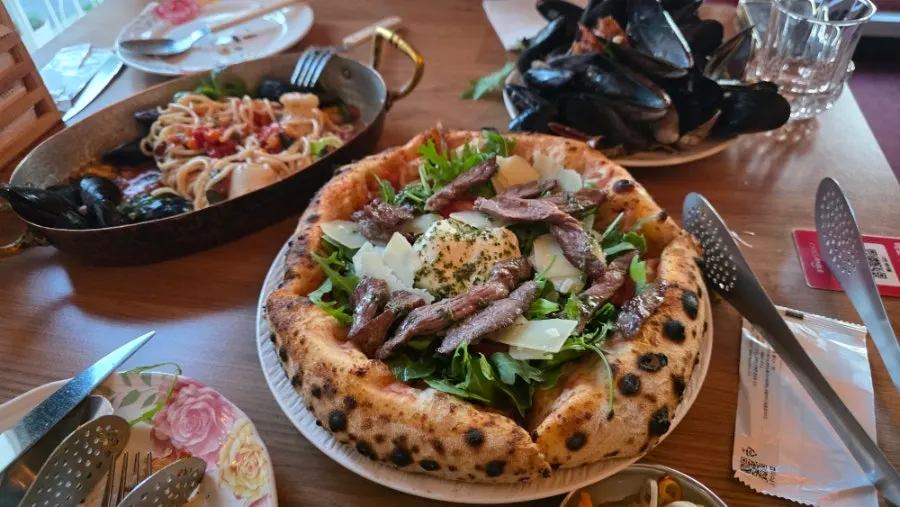 A plate with a slice of pizza and pasta together