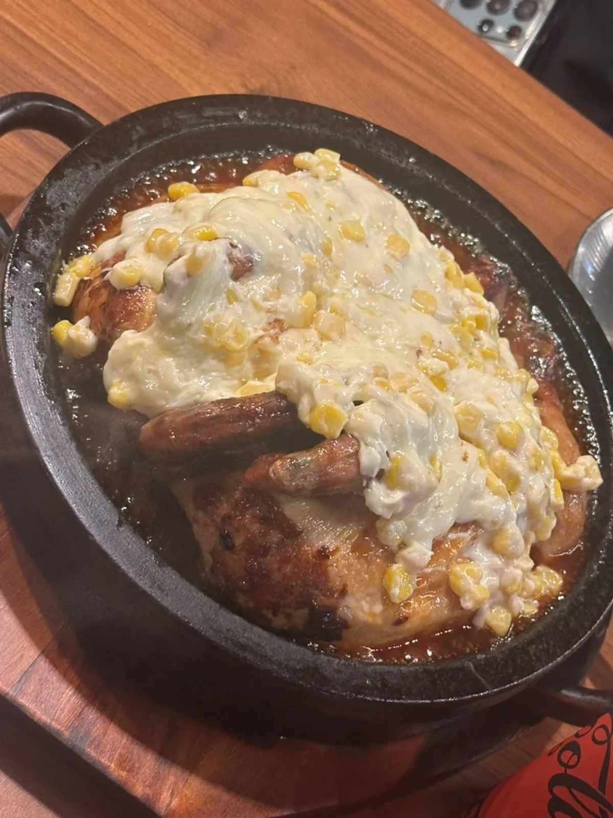 Corn cheese gratin seasoned oak-fired chicken served on a hot stone plate