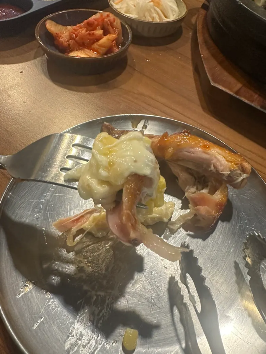 A piece of chicken rolled up with melted cheese