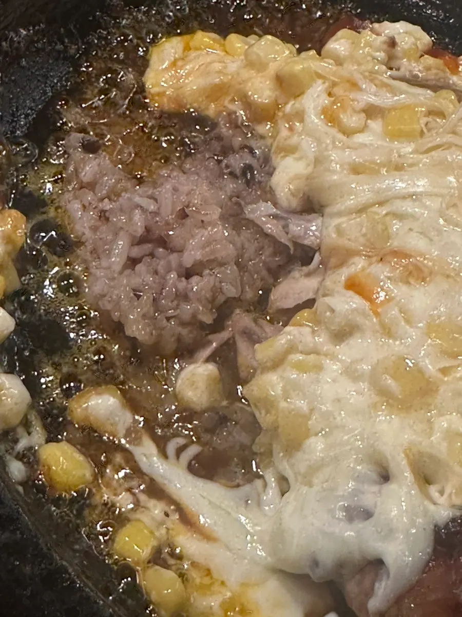 Sticky rice and seasoning sauce laid at the bottom of the hot stone plate