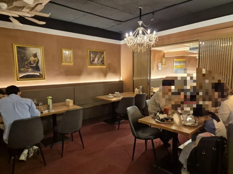 Dining hall with framed pictures and mask decorations on the wall