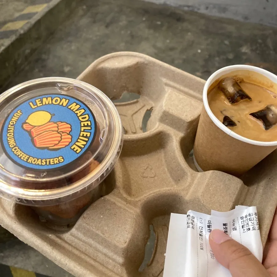 Drink and madeleine in an egg-carton-shaped carrier