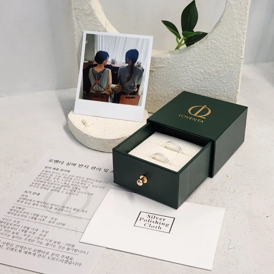 Green Loventa box holding the finished rings and a polaroid photo