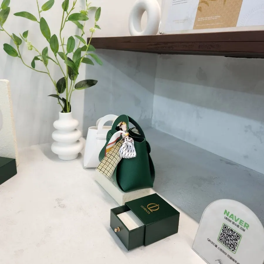 Ring box placed inside the green pouch