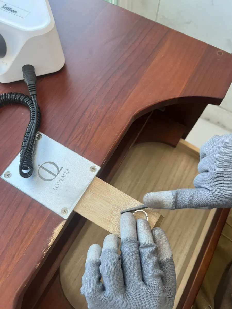 Two people sitting across from each other making rings