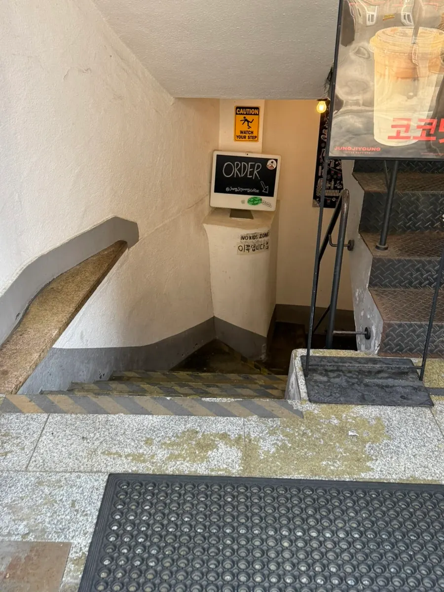 Stairway entrance to the café, which has no elevator