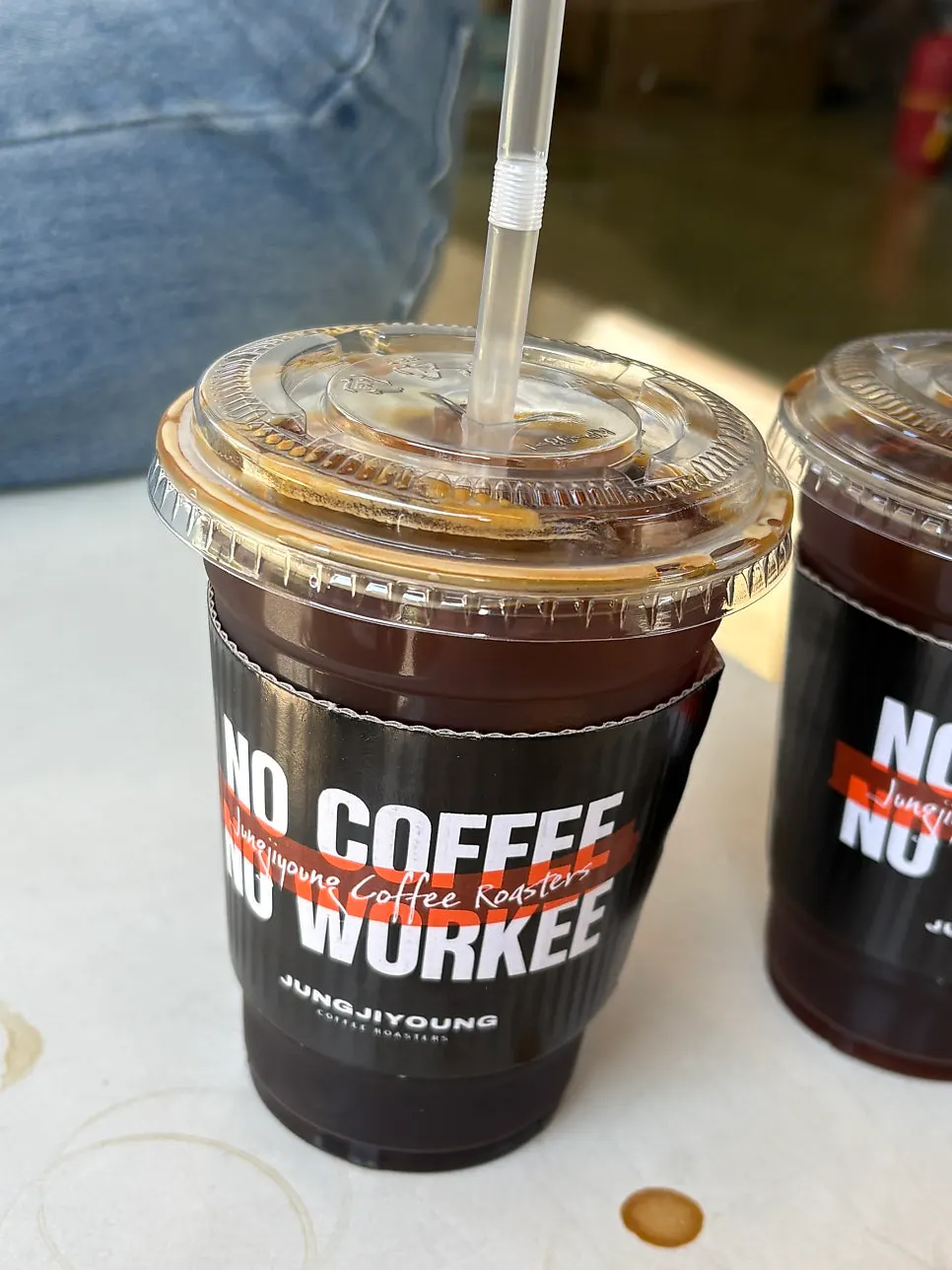 Standing while holding takeout coffee