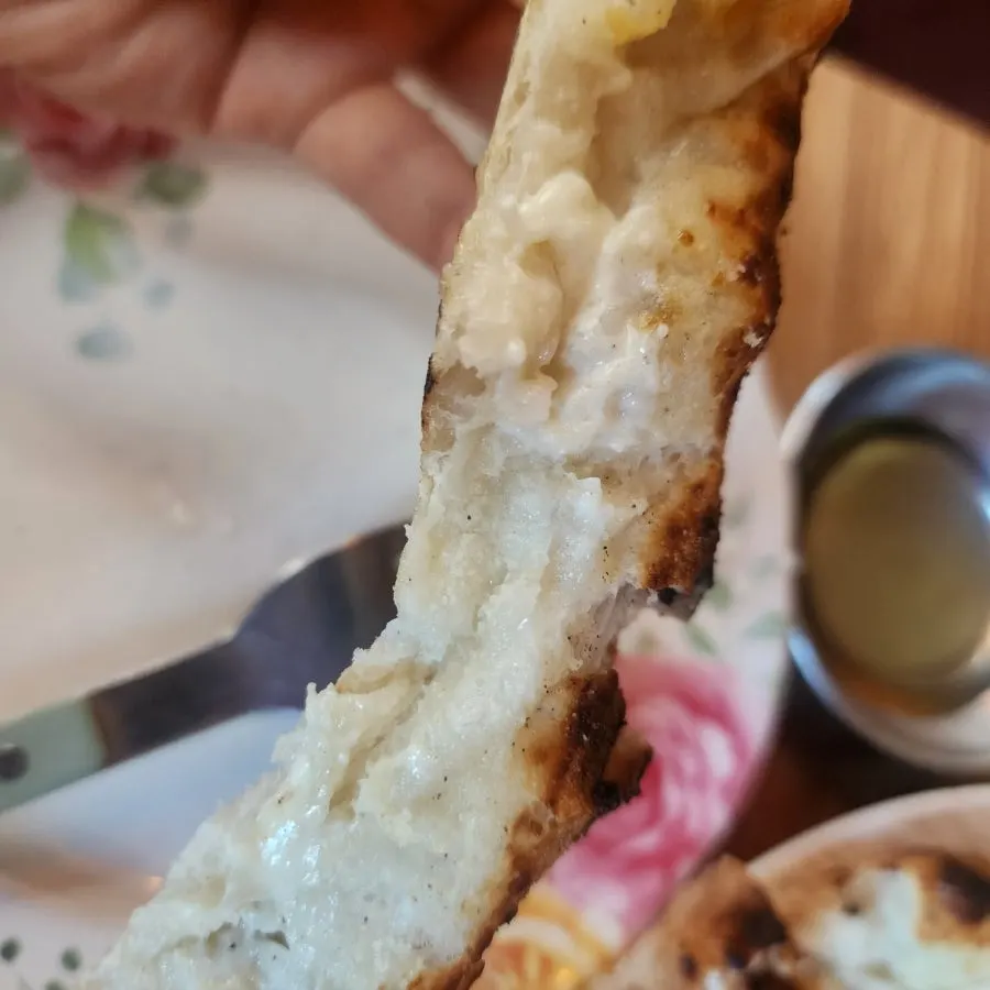 Shredded pickled radish and honey served with pizza