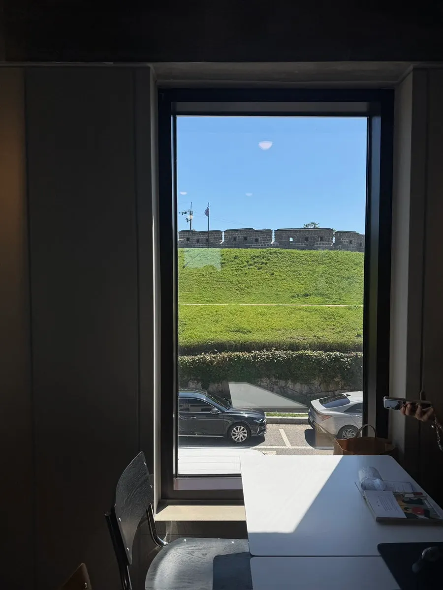 Drinks and bread on a window table for four