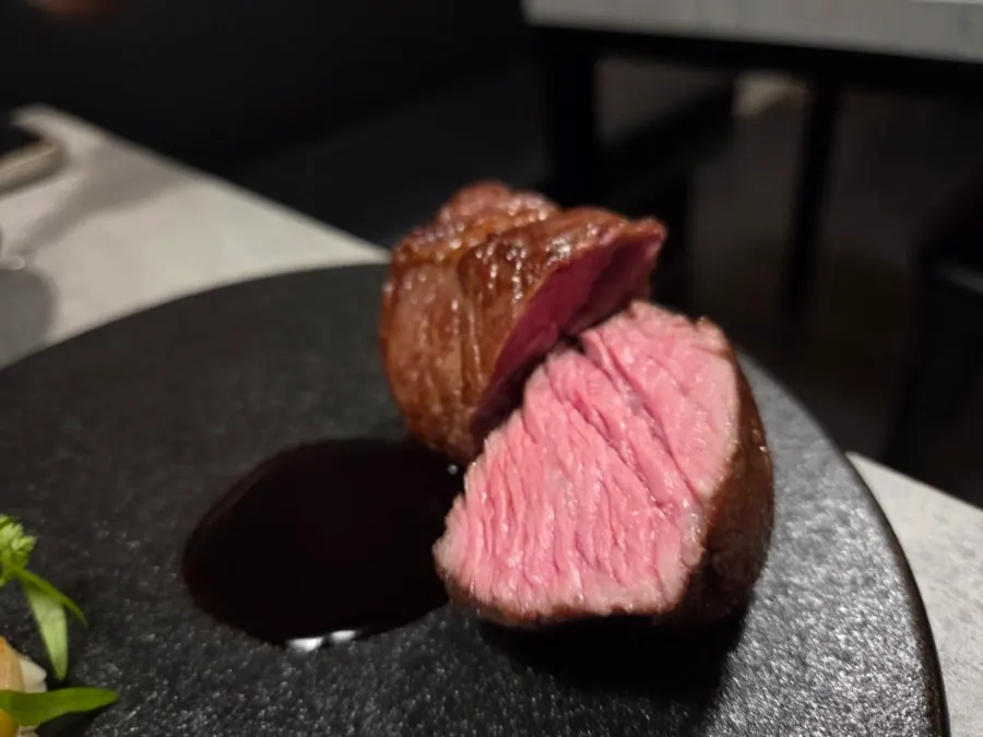 Chuck flap steak served on a black plate
