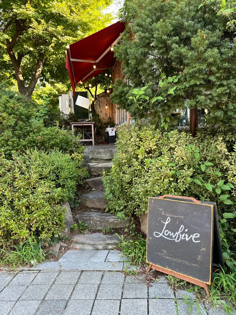 Exterior of Low Five hidden behind trees