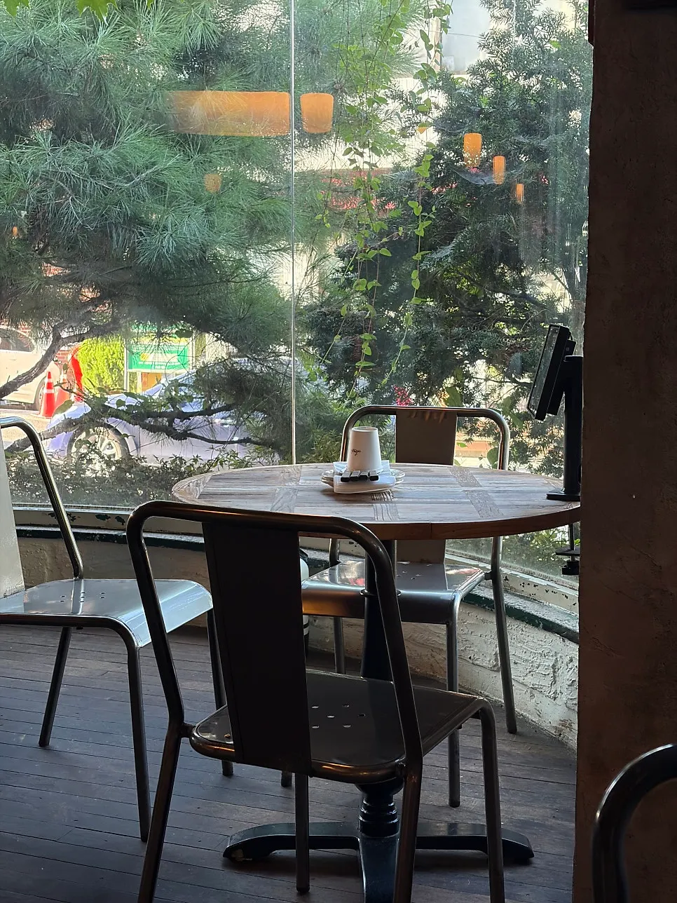 Window-side seating at Low Five with pine tree views