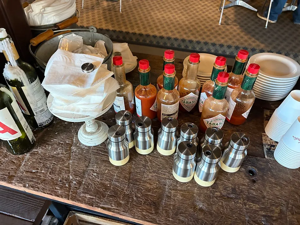 Self-serve bar with Parmesan cheese and chili sauce