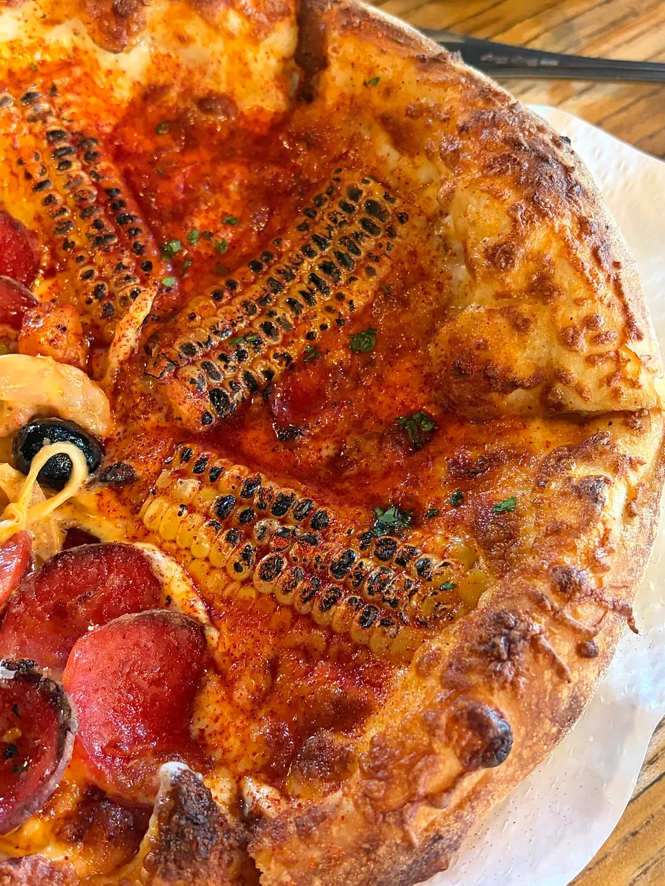 White truffle cream pizza topped with grilled corn