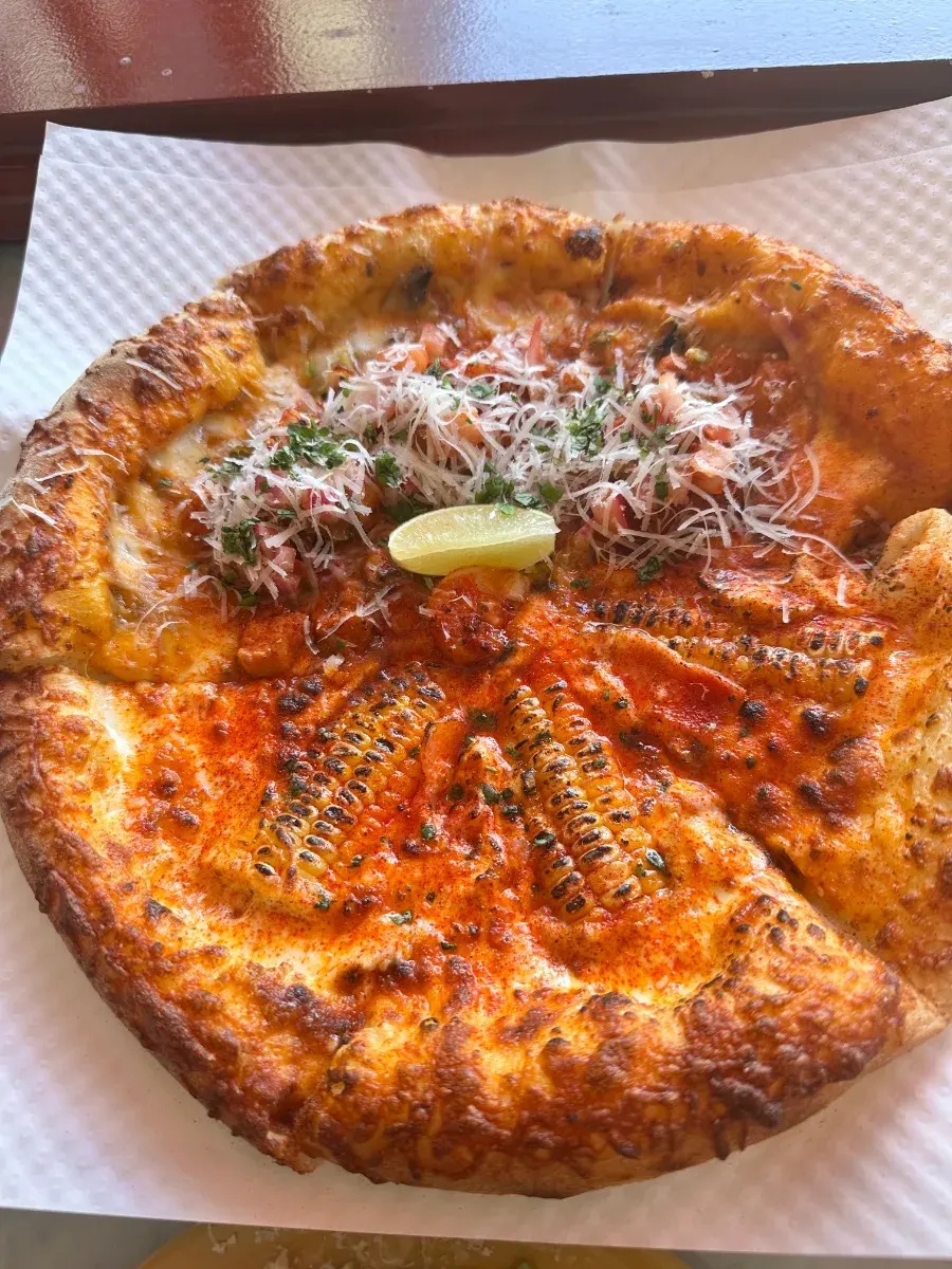 Half corn and half taco pizza
