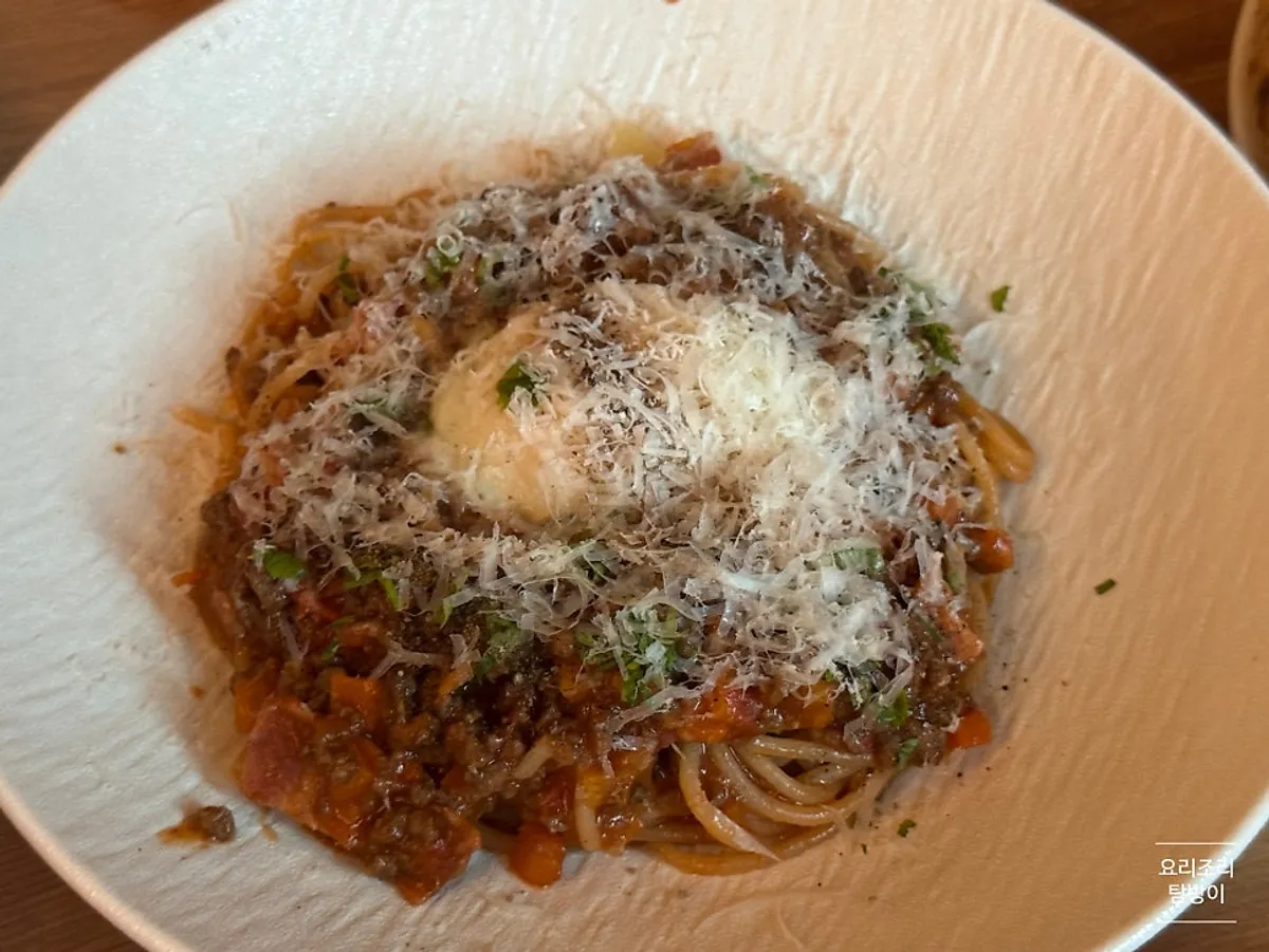 Beef ragu fresh pasta topped with a poached egg