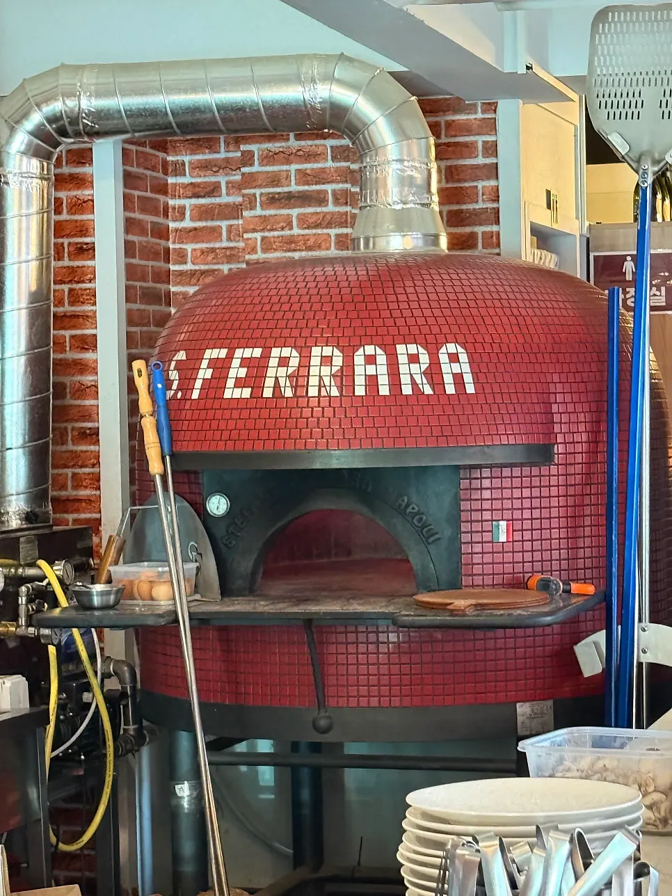 Space with the red wood-fired oven