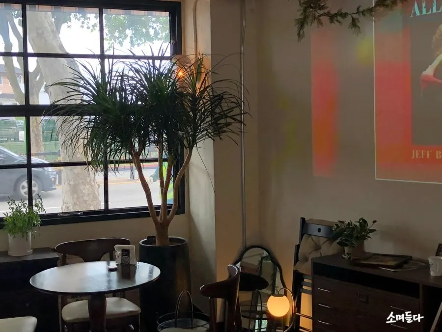 Plants and wood-toned decor at Nonchalant Lounge