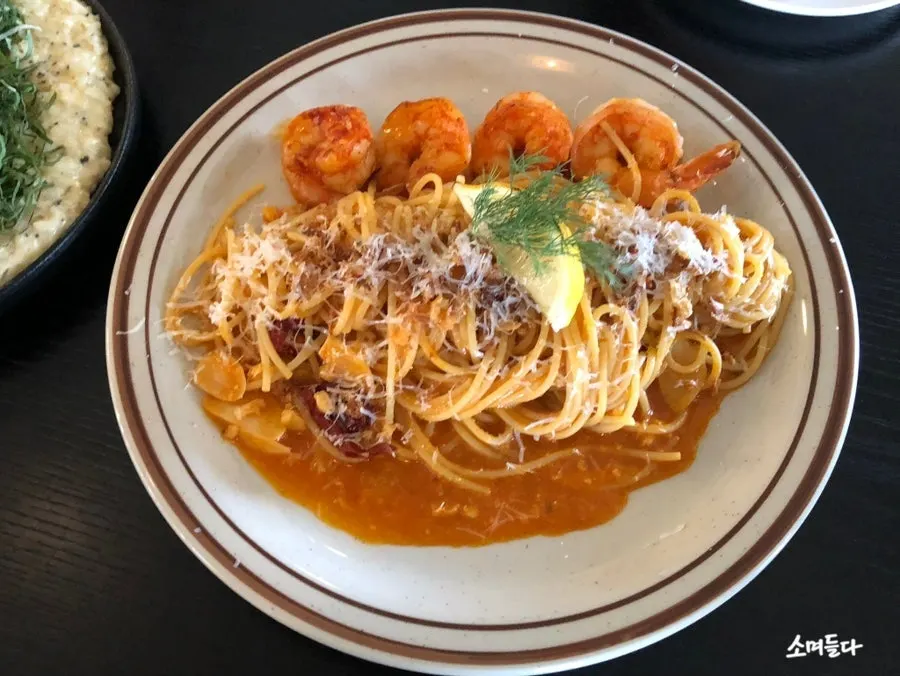 Bisque rosé pasta topped with shrimp