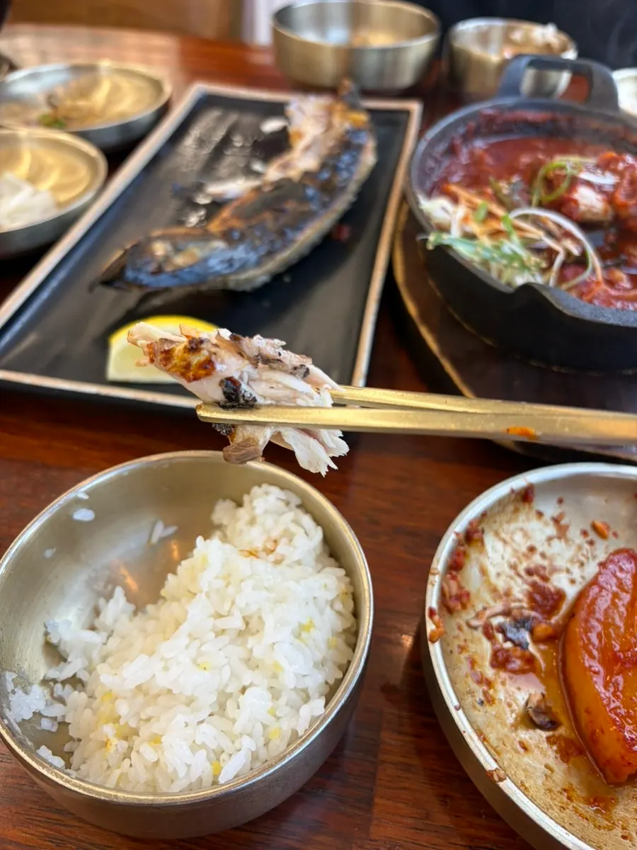 Eating grilled mackerel