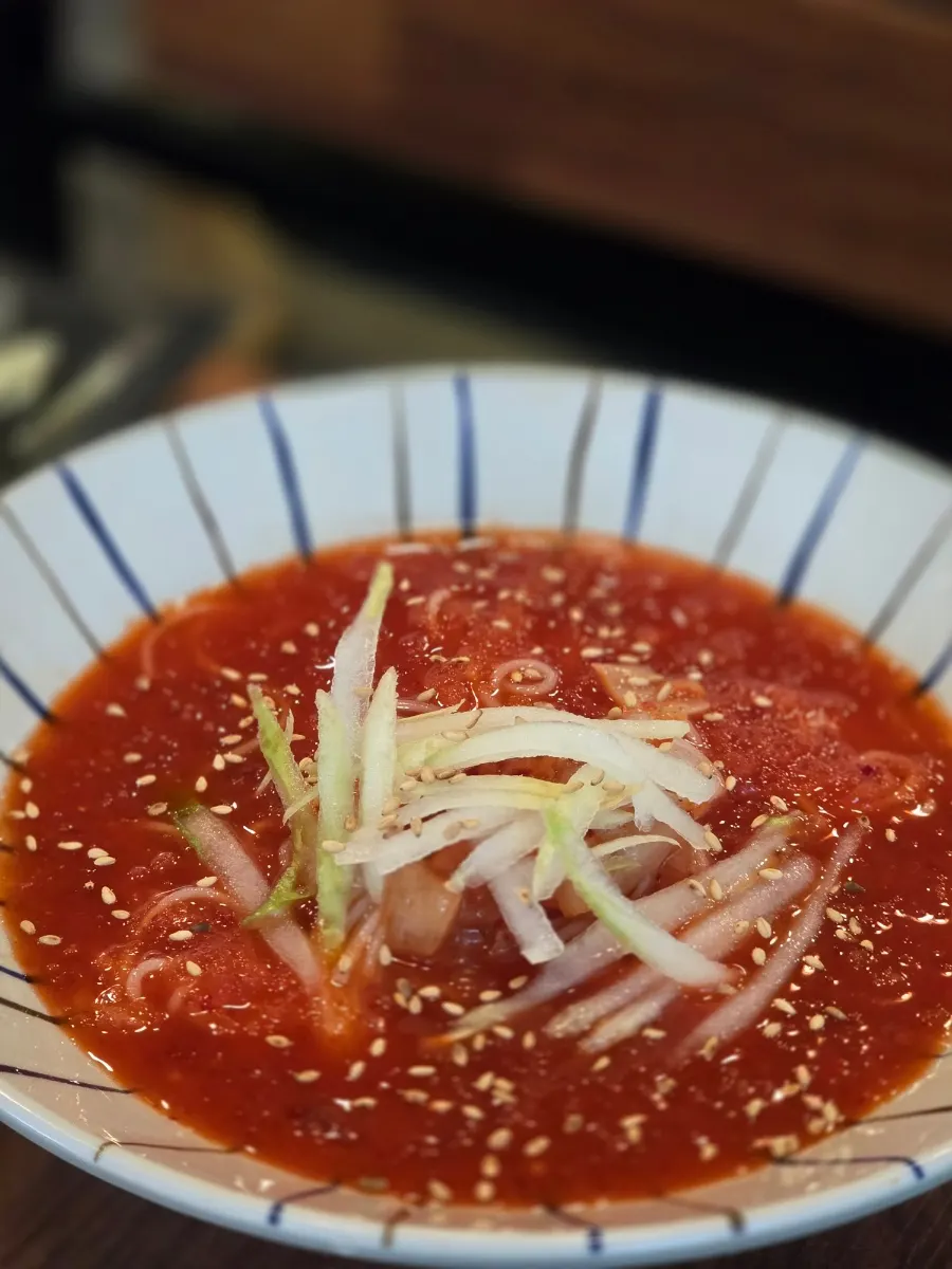 Kimchi noodle strands eaten alongside the eel