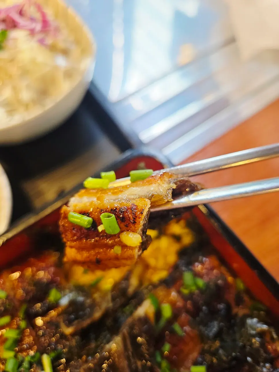 Rice bowl with seaweed and eel over yellow-tinted rice