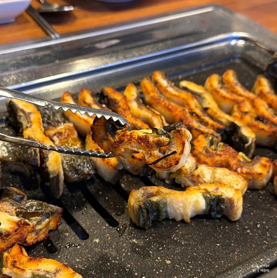 Pre-cooked freshwater eel placed on the grill
