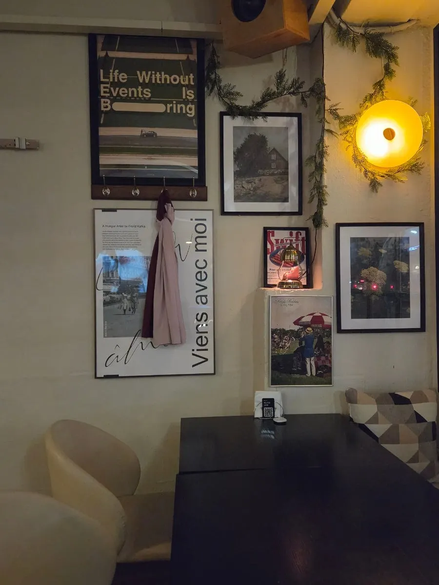 Interior of Nonchalant Lounge with wood-tone furniture and orange lighting