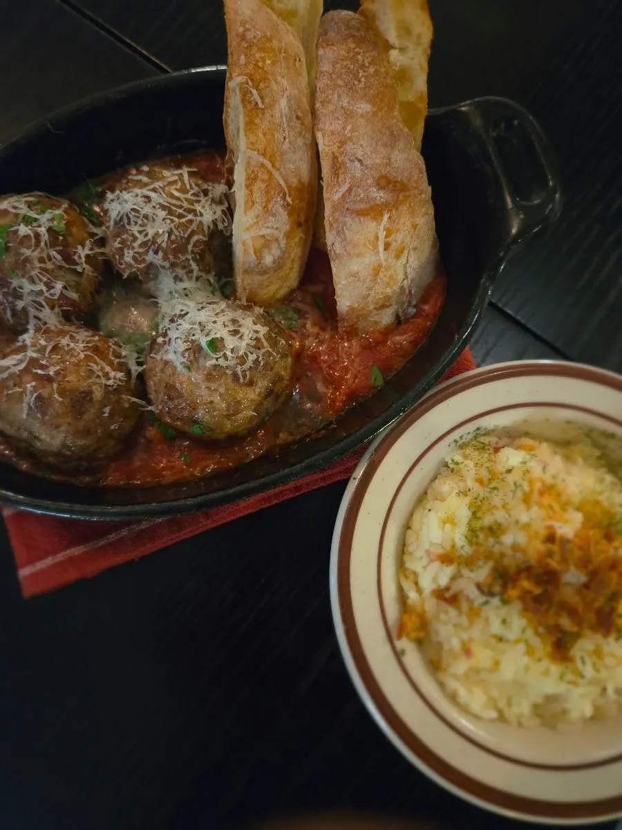 Homemade meatballs and French baguette with tomato sauce