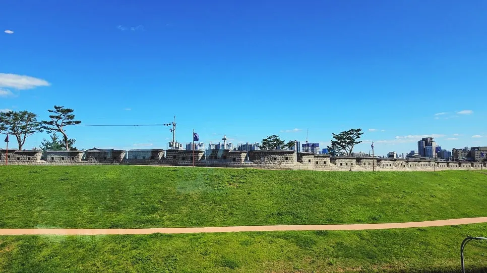 View through the window of the Hwaseong Fortress wall and grassy hill