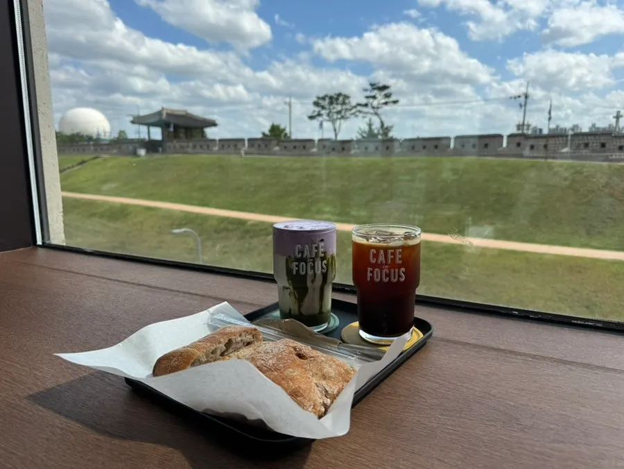 Drinks and bread set against a backdrop of the fortress view