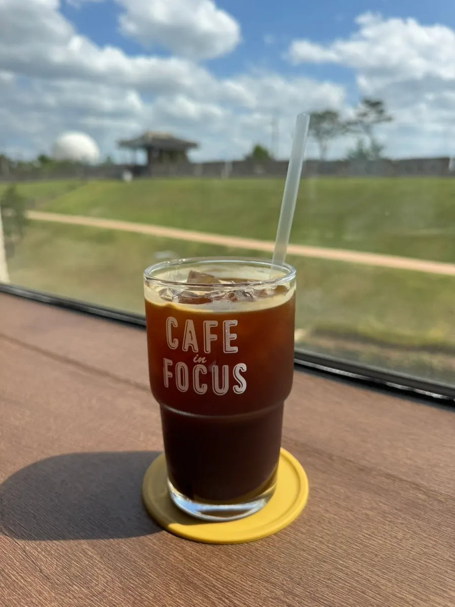 Close-up of an iced americano by the window