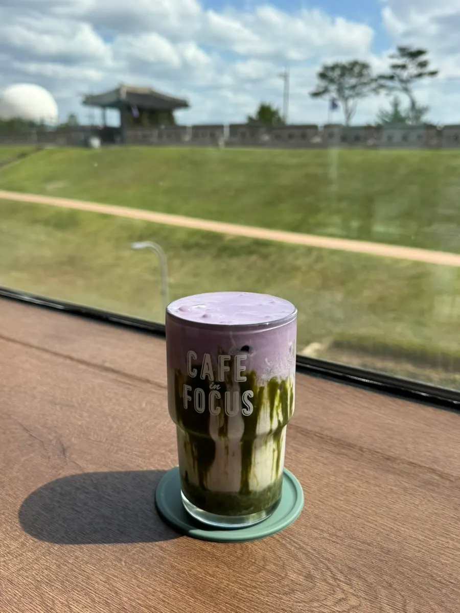 Ube cream matcha latte topped with ube cream
