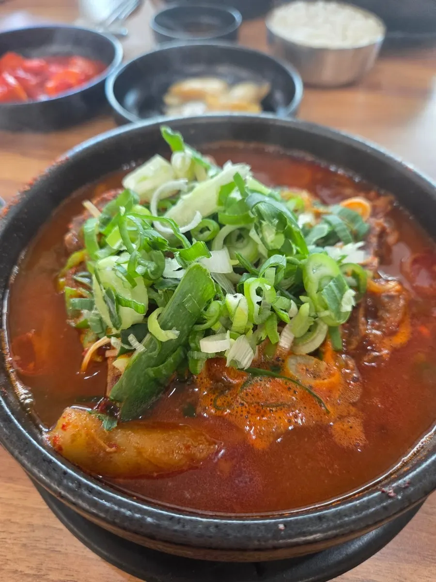 Spicy pork bone soup bubbling in a stone pot