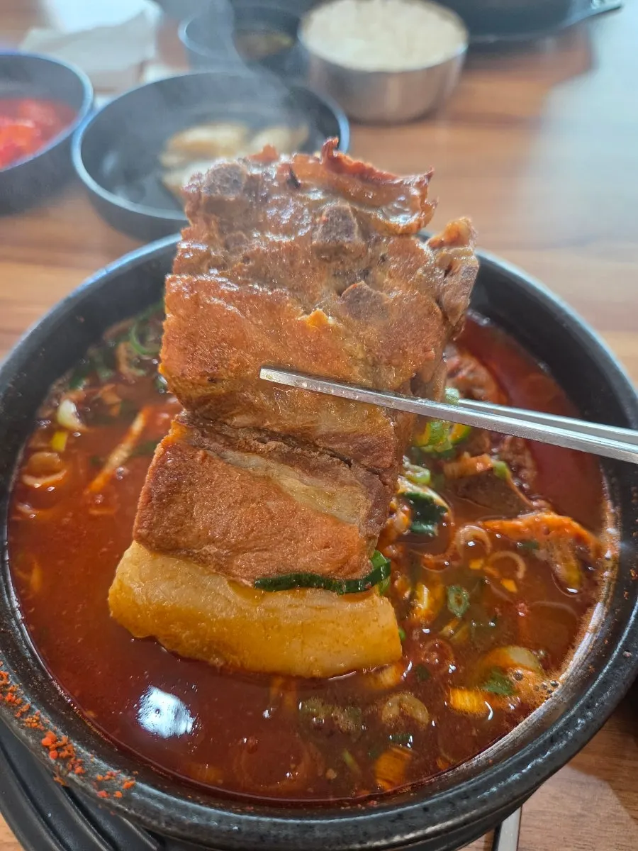 Picking meat off a big pork bone