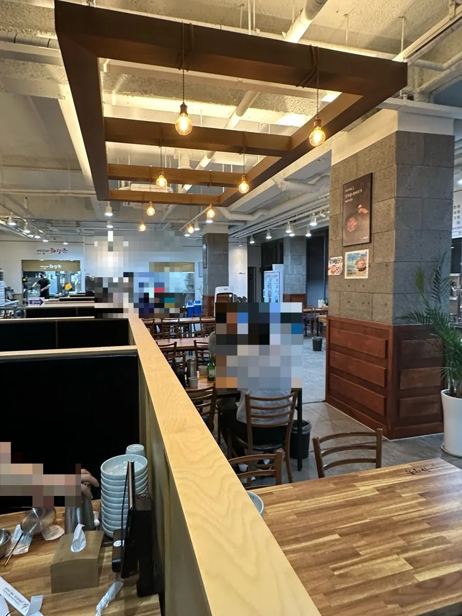 Spacious restaurant interior with wood-tone tables