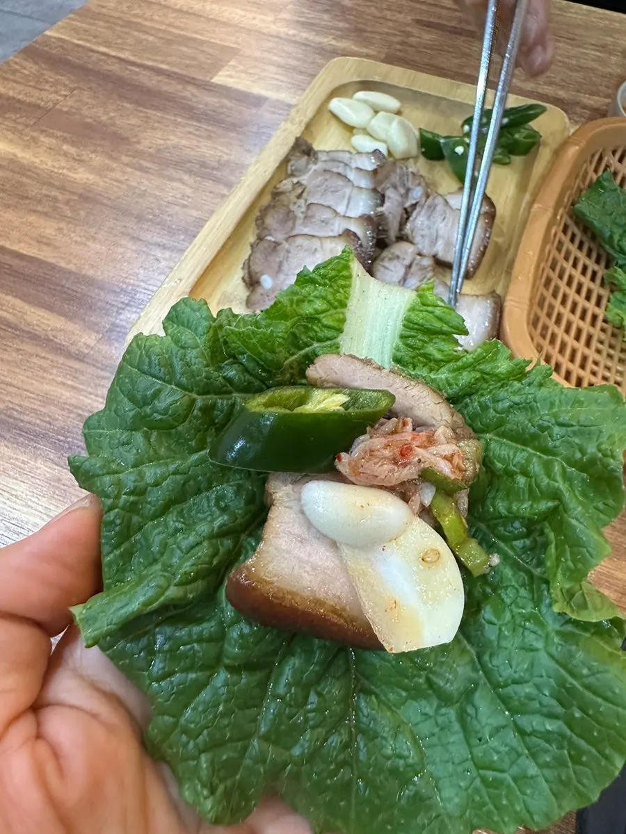 Side dish plate with lettuce leaves, garlic, and chili