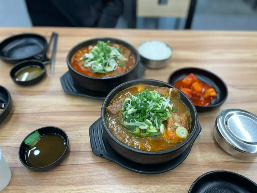 A bowl of pork bone soup with bones piled above the broth