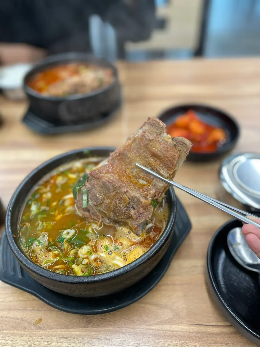Spicy pork bone soup eaten together with an extra bowl of rice