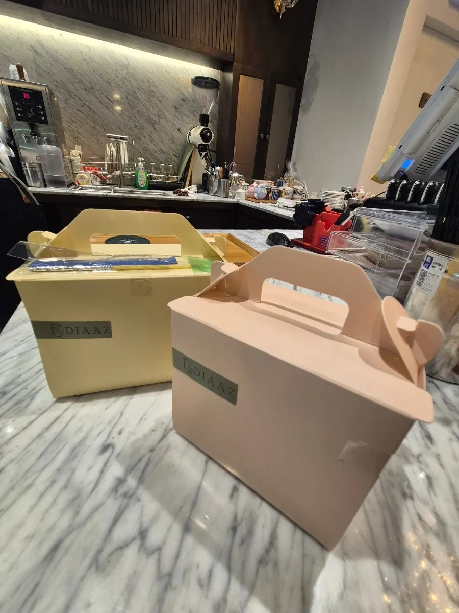 Takeout box containing three cake slices