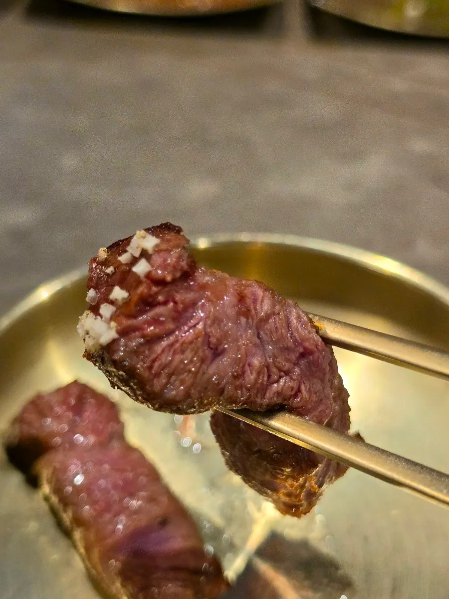 Sirloin being turned and grilled