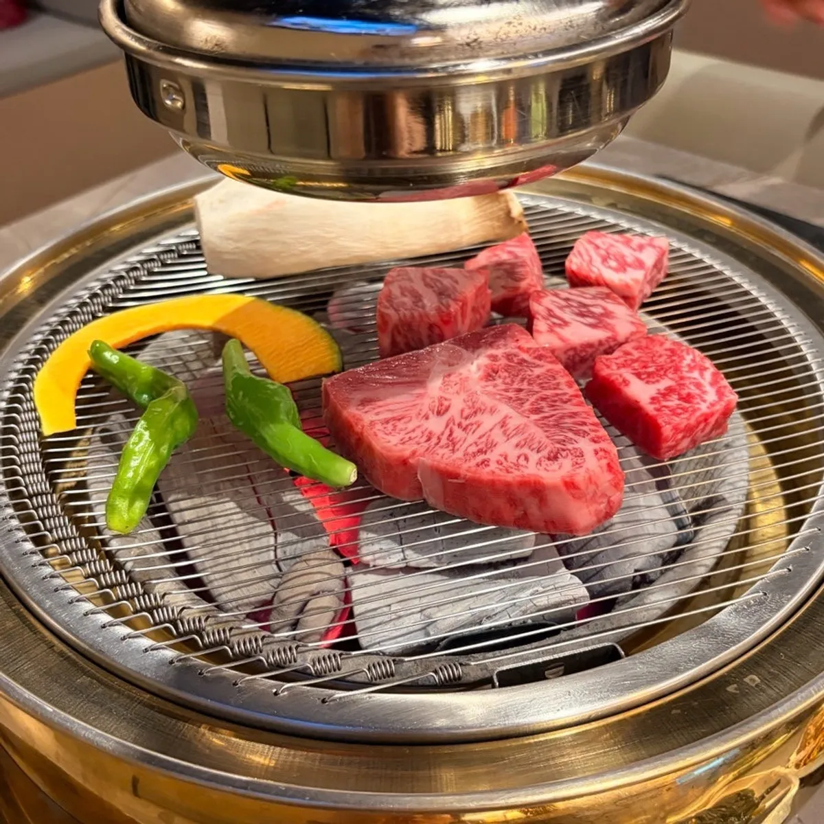 Hanwoo grilling over the charcoal fire