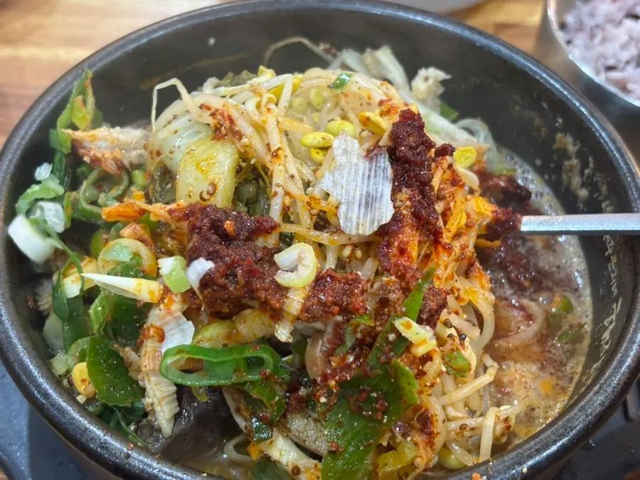 Close-up of tripe soup broth full of bean sprouts