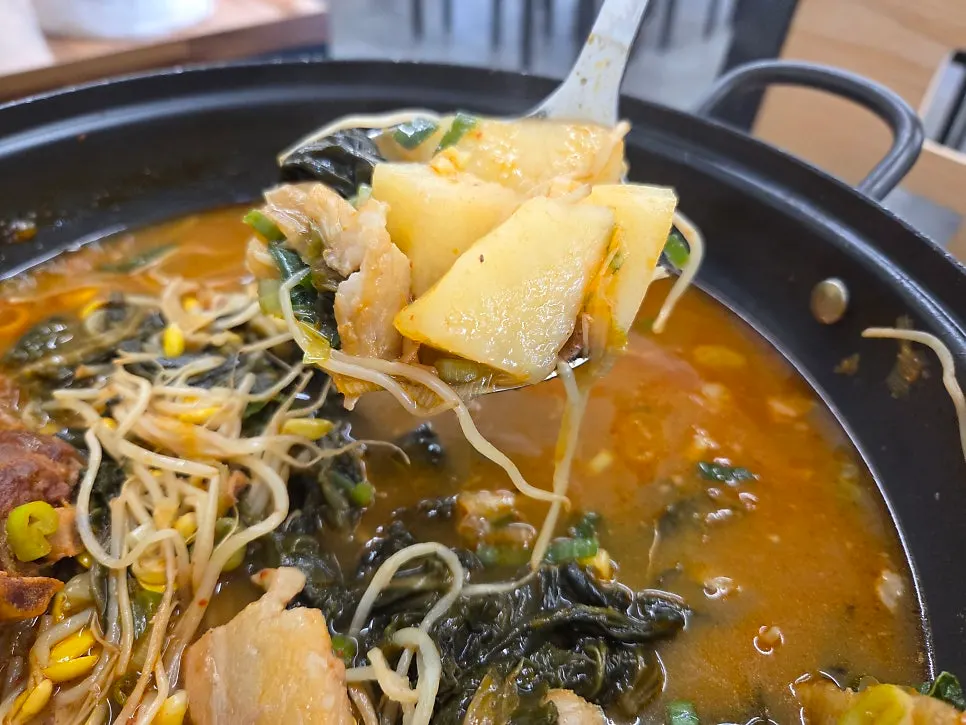 Spicy gamjatang broth with a bowl of rice