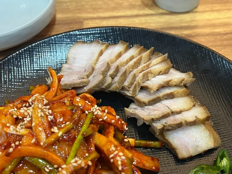 A piece of dombe pork topped with yangmuchim