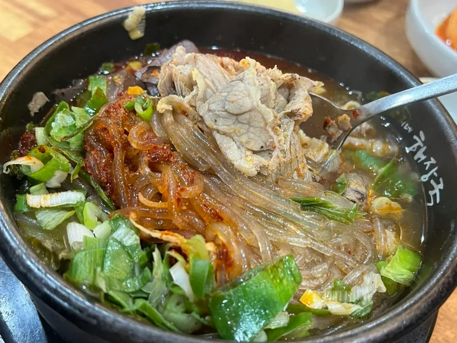 Close-up of haejangguk broth with glass noodles