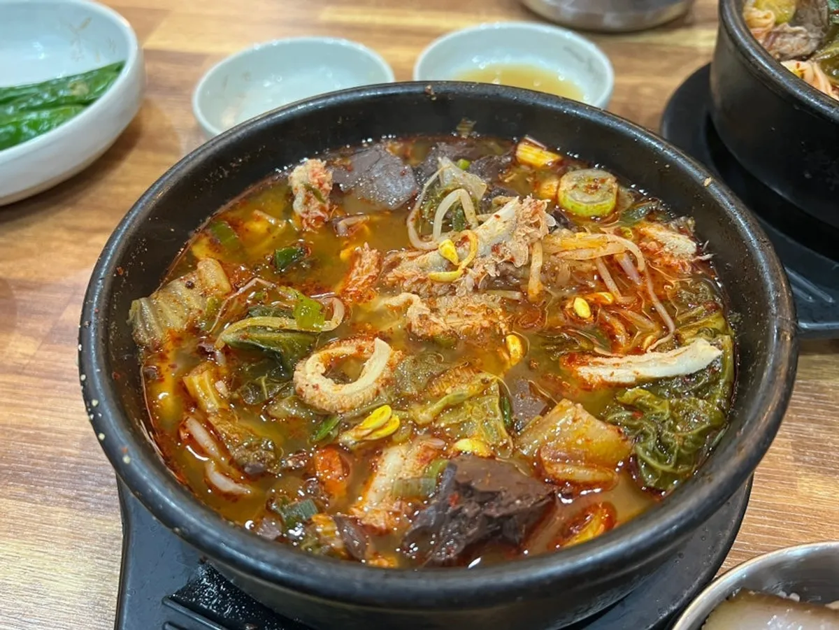 A spoonful of chewy tripe lifted from the soup