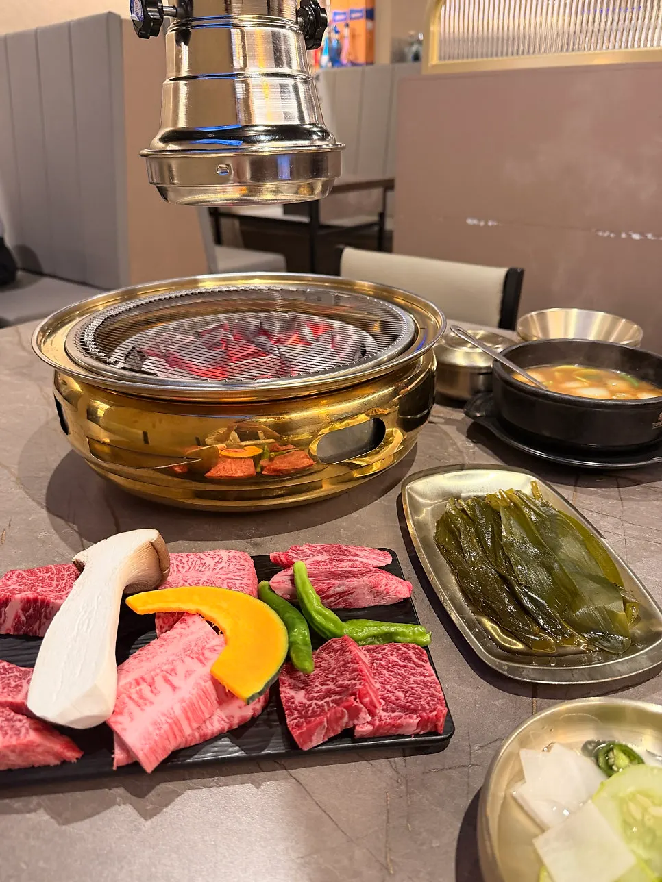 Gold-colored grill filled with charcoal